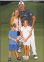  ?? Kevin C. Cox / Getty Images ?? Brandt Snedeker stands with his wife Mandy as their children Austin and Lily hold the tophy after he won the Wyndham Championsh­ip Sunday.