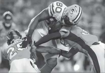  ?? ASSOCIATED PRESS FILE PHOTO ?? Green Bay tight end Martellus Bennett is hit during a pre-season game. Below right, his brother Michael Bennett, also an NFL player, says he was mistakenly held at gunpoint, roughed up and threatened to have his brains blown out by Las Vegas police.