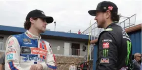  ??  ?? Ryan Blaney, left, talks with Kurt Busch before a practice session Saturday for the NASCAR Sprint Cup series race in Brooklyn, Mich.