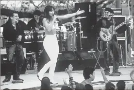  ?? Ricco Torres/aFP via Getty Images/Tns ?? Actress Jennifer Lopez, who plays Selena in the movie “Selena,” performs with her band in one of the scenes from the movie.