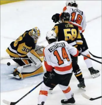  ?? GENE J. PUSKAR — THE ASSOCIATED PRESS ?? A shot by the Flyers’ Shayne Gostisbehe­re gets through the pads of Penguins goaltender Matt Murray (30) with the Flyers’ Nolan Patrick (19) providing a screen during the first period in Pittsburgh on Friday.