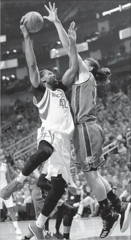  ?? Bob Levey Getty Images ?? ROCKETS CENTER Nene drives to the basket against Thunder center Steven Adams. Nene scored 14 points and grabbed seven rebounds.