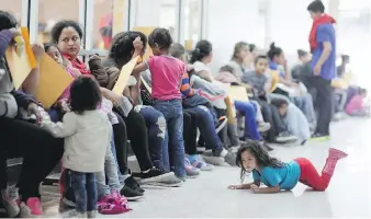  ?? ROBERT GAUTHIER, LOS ANGELES TIMES ?? In McAllen, Texas, a group of released detainees gather at a bus station Wednesday before walking a few blocks to the Catholic Charities Respite Center. One woman from Honduras said she was never separated from her infant. She said children up to seven...