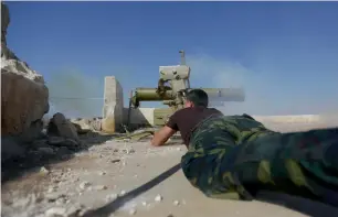  ?? Reuters ?? A rebel fighter in Marea city fires a weapon towards Syria Democratic Forces-controlled Tell Rifaat town, northern Aleppo province. —