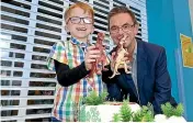  ??  ?? Southland Hospital patient Thomas Walker, with Southern DHB Chief Executive Officer Chris Fleming, about to cut the cake to celebrate 12 years of the Countdown Kids Hospital Appeal. JOHN HAWKINS/STUFF