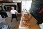  ?? CZAREK SOKOLOWSKI — THE ASSOCIATED PRESS ?? Bozena Legowska makes free pizzas for the doctors and medics of the Bielany hospital in Warsaw, Poland.