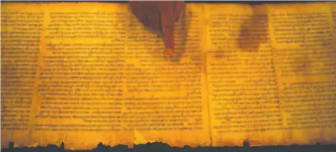  ?? (Baz Ratner/Reuters) ?? THE ORIGINAL Isaiah Scroll inside a secured climate-controlled room in the Shrine of the Book at the Israel Museum in Jerusalem.