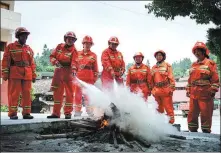  ?? PHOTOS BY JIN KEWEN / FOR CHINA DAILY ?? Clockwise from top: Nestling in a valley surrounded by woods, Mushan village in Tianzhu county, Guizhou province, is known for many traditiona­l wood houses. Members of the voluntary fire brigade put out a fire during a weekly drill in the village. Liu Qiuling, leader of the voluntary fire brigade, checks firefighti­ng equipment at the team’s office.