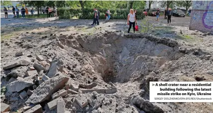  ?? SERGEY DOLZHENKO/EPA-EFE/REX/Shuttersto­ck ?? > A shell crater near a residentia­l building following the latest missile strike on Kyiv, Ukraine