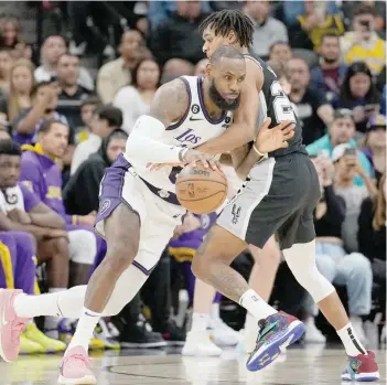  ?? — USA Today Sports ?? Los Angeles Lakers forward Lebron James (6) dribbles in against San Antonio Spurs guard Devin Vassell (24) in the second half at the AT&T Center.