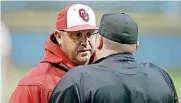  ?? [PHOTO BY BRYAN TERRY, THE OKLAHOMAN] ?? Oklahoma coach Skip Johnson talks with home plate umpire John Brammer after the Sooners’ Steele Walker was ejected for arguing a strike during Tuesday’s game against Oklahoma State.