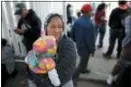  ?? GREGORY BULL — THE ASSOCIATED PRESS ?? Maria Rafaela Blancante, of the Mexican state of Michoacan, holds her daughter, Jazmin, as they wait with other families to request political asylum in the United States, across the border in Tijuana, Mexico.