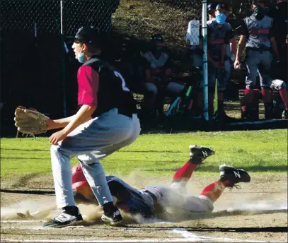  ?? PHOTOS BY BRIAN SUMPTER ?? Clear Lake’s Ryan Ollenberge­r slides home with the first run of the game as Colusa pitcher Luke Kalfsbeek covers home plate Tuesday afternoon in Lakeport. Colusa won 7-5 in eight innings.