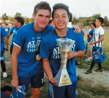  ??  ?? Cebuano booters Valentino "Val" B. Calvo (L) and Gico Noel proudly pose with their championsh­ip trophy after helping the Ateneo Blue Booters dominate the 75th UAAP men's football tournament last week. Both Calvo and Noel are products of Don Bosco...