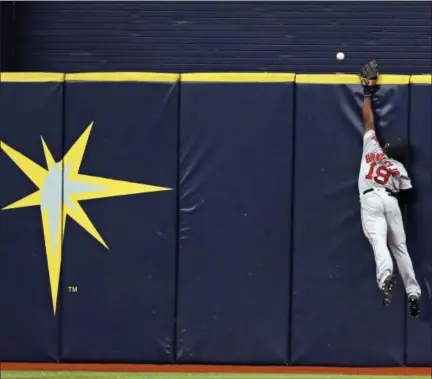  ?? MIKE CARLSON — THE ASSOCIATED PRESS ?? Boston Red Sox center fielder Jackie Bradley Jr. reaches for a home run hit by Tampa Bay Rays' Brad Miller during the eighth inning of a baseball game Sunday in St. Petersburg, Fla.