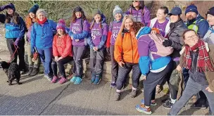  ?? ?? ● Anglesey Hospice staff nurses, their families and friends decided that they would celebrate the second anniversar­y together by trekking 11 miles; right, the trekkers at the summit of Holyhead Mountain