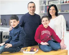  ??  ?? Let them eat fruit… Daniel, Jacob and parents Sarah and Ronnie are now sugar-free