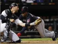  ?? NAM Y. HUH — THE ASSOCIATED PRESS ?? The Indians’ Jose Ramirez scores as White Sox catcher Kevan Smith is late with the tag during the ninth inning.