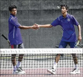  ?? RALPH BARRERA / AMERICAN-STATESMAN ?? LBJ High’s Chaitanya Aduru (left) and Vishwa Aduru congratula­te each other during a 6-4, 6-3 victory Friday over the Lubbock High team of Cody Baker and Kody Kothmann to win the Class 5A boys doubles crown.