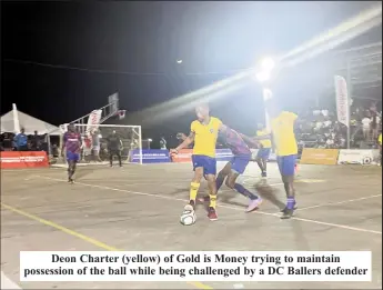  ?? ?? Deon Charter (yellow) of Gold is Money trying to maintain possession of the ball while being challenged by a DC Ballers defender