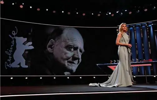 ??  ?? A picture of Swiss actor Bruno Ganz who died yesterday is displayed as German TV host Anke Engelke addresses the awards ceremony of the 69th Berlinale film festival.