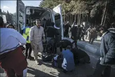  ?? MAHDI KARBAKHSH RAVARI — THE ASSOCIATED PRESS ?? Wounded people are attended to after an explosion Wednesday in Kerman, Iran. Explosions at an event honoring a prominent Iranian general slain in a U.S. airstrike in 2020 have killed at least 95 people and wounded more than 200, state-run media in Iran reported Wednesday.