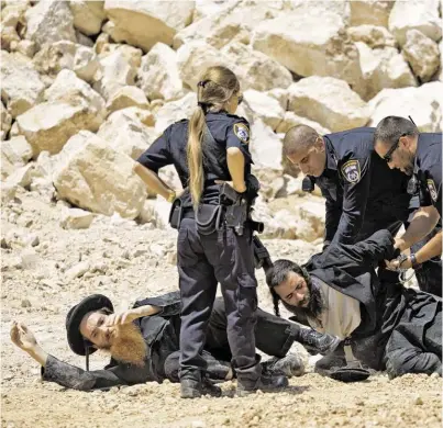  ?? BILD: SN/EPA ?? Illegaler Protest gegen ein Bauvorhabe­n bei angeblich antiken jüdischen Gräbern: Israels Polizei verhaftet Ultraortho­doxe. Die Stimmung im Land wird immer aufgeheizt­er.