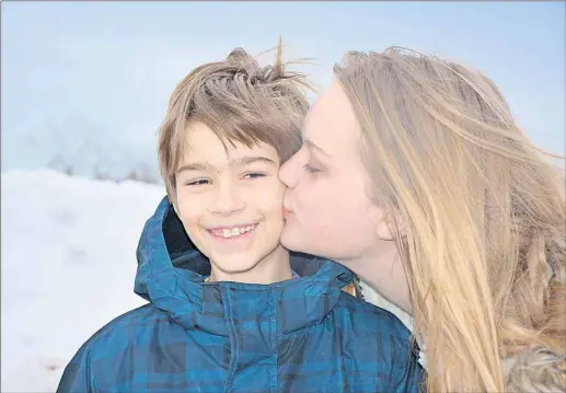  ?? ANCELENE MACKINNON/TC MEDIA ?? Quinn Harrington gets a kiss from his older sister, Hannah, who is encouragin­g all P.E.I. elementary schools to participat­e in her Heart Art Show, which raises money for the IWK Health Centre. Quinn underwent open-heart surgery at the hospital when he...