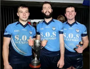  ??  ?? St. Anne’s joint captains Seamus Mythen and Mark Furlong with full-back Tomás Cullen who won the man of the match award.