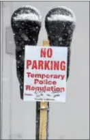  ??  ?? At left, signs warn motorists not to park on Brookline Boulevard in Haverford Township as the snow comes down hot and heavy Wednesday, forcing officials to declare a snow emergency.