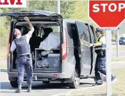  ??  ?? HOME TOWN Armed police searching vehicles going into Ripoll yesterday