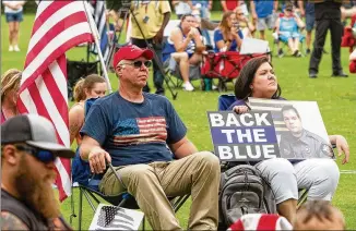  ?? STEVE SCHAEFER / FOR THE AJC ?? People gather for a rally Saturday in support of law enforcemen­t at Lost Mountain Park in Powder Springs. Meanwhile, in southwest Atlanta, families of Black men and women killed by police called for prosecutio­n of their cases in the courts.