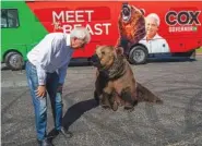  ?? RENEE C. BYER/THE SACRAMENTO BEE VIA AP ?? John Cox, Republican recall candidate for California governor, begins his statewide “Meet the Beast” bus tour on Tuesday with Tag, a Kodiak brown bear, in Sacramento.