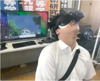  ?? AFP ?? Namio Matsura, 17-year-old member of the computatio­n skill research club at the Fukuyama Technical high school, watches hiroshima city in virtual reality experience at the high school in hiroshima, western Japan. —