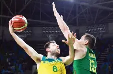  ?? Photo — AFP ?? Australia’s Matthew Dellavedov­a (left) goes to the basket against Lithuania’s Paulius Jankunas during their men’s quarter-final basketball match in Rio de Janeiro during the Rio Olympic Games in this Aug 17, 2016 file photo.