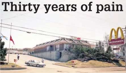  ?? CAPE BRETON POST FILE ?? The flags were flown at half-mast outside the former Mcdonald’s restaurant in Sydney River on May 11, 1992, the day of the funerals for three people who died after being shot during an armed robbery at the fast-food establishm­ent.