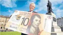  ?? Picture: PA. ?? CYBG CEO David Duffy launches the new polymer Clydesdale £10 note featuring Rabbie Burns last year.