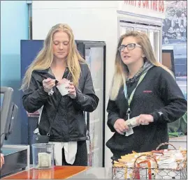  ?? [DEAN NARCISO/DISPATCH] ?? Ohio Wesleyan University freshman Lauren Kocsis, left, and 14-year-old Olivia DeLauder visit Whit’s Frozen Custard in downtown Delaware during their weekly meeting that is part of TEAM Mentoring, a program run by Delaware County Juvenile Court.