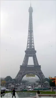  ?? AFP ?? a banner reading ‘liberty, equality, fraternity’ hung by Greenpeace activists on eiffel tower in Paris. —