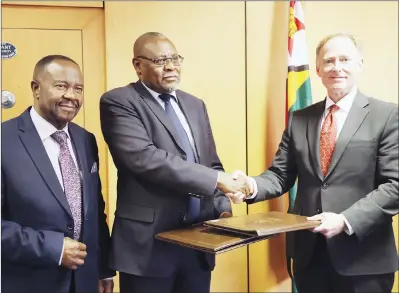  ??  ?? Infrastruc­ture Developmen­t Bank of Zimbabwe (IDBZ) Chief Executive Officer Dr Thomas Zondo Sakala (centre) and Hondius Capital Management managing director Mr Jack Hefferman (right) exchange documents while One-stop Investment Services Centre chairman and Permanent Secretary in the Office of the President and Cabinet Dr Washington Mbizvo (left) witness during the signing ceremony in Harare yesterday. — (Picture by Memory Mangombe)