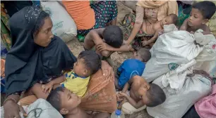  ?? AP ?? Children sleep near a relief distributi­on centre in Kutupalong refugee camp, Bangladesh. —