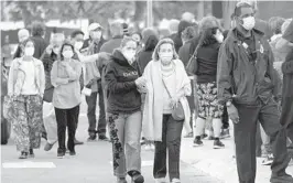  ??  ?? People arrive at Jackson Memorial Hospital to receive the COVID-19 vaccine in Miami in this file photo. LYNNE SLADKY/AP