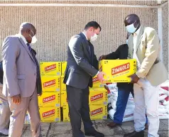  ??  ?? Russian Ambassador to Zimbabwe Mr Nikolai Krasilniko­v (centre) hands over food items to Secretary for War Veterans in the Politburo Cde Douglas Mahiya (right), while war veterans national chairman Cde Christophe­r Mutsvangwa looks on at ZANU PF Headquarte­rs yesterday