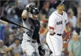  ?? Michael Dwyer ?? The Associated Press Steve Pearce flips his bat near Yankees catcher Austin Romine after hitting the second of his three home runs Thursday in the Red Sox’s 15-7 win at Fenway Park.