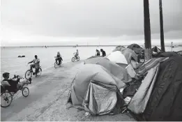  ?? JAE C. HONG/AP ?? A homeless encampment is set up along the boardwalk during June in the Venice neighborho­od of Los Angeles. The share of Americans living in poverty rose slightly as the COVID-19 pandemic shook the economy last year, the Census reported Tuesday.