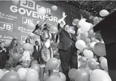  ?? Associated Press, File ?? ■ Democratic gubernator­ial candidate J.B. Pritzker, right, and his running mate, Juliana Stratton, celebrate Tuesday as they wave to supporters after defeating Republican incumbent Bruce Rauner in Chicago. Democrats who gained new or expanded powers in state elections are gearing up for a left-leaning push on gun control, universal health care and legal marijuana. Meanwhile, some Republican legislatur­es that have cut taxes and limited union powers are adjusting to a new reality of needing to work with a Democratic governor.