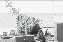  ?? ANDREW VAUGHAN THE CANADIAN PRESS ?? A Canadian Coast Guard vessel containing diesel and hydraulic fuel was cut from its cradle at a Nova Scotia shipyard and is partially submerged.