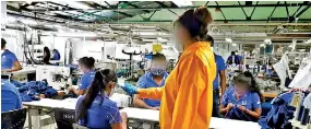  ??  ?? Fever checks being carried out at a factory in Katunayake