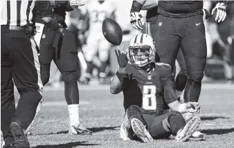  ?? THE ASSOCIATED PRESS ?? Tennessee Titans quarterbac­k Marcus Mariota tosses the ball to an official after being sacked for a 10-yard loss by the Indianapol­is Colts in the second half of their game Sunday in Nashville.