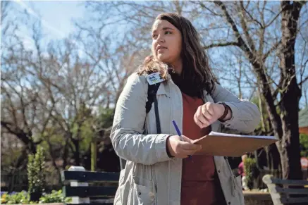  ?? PHOTOS BY MAX GERSH/THE COMMERCIAL APPEAL ?? Rhodes College environmen­tal sciences student Natalie Thomas keeps an eye on her watch as she collects behavioral data on elephants at the Memphis Zoo. Thomas recorded notes at two-minute intervals.